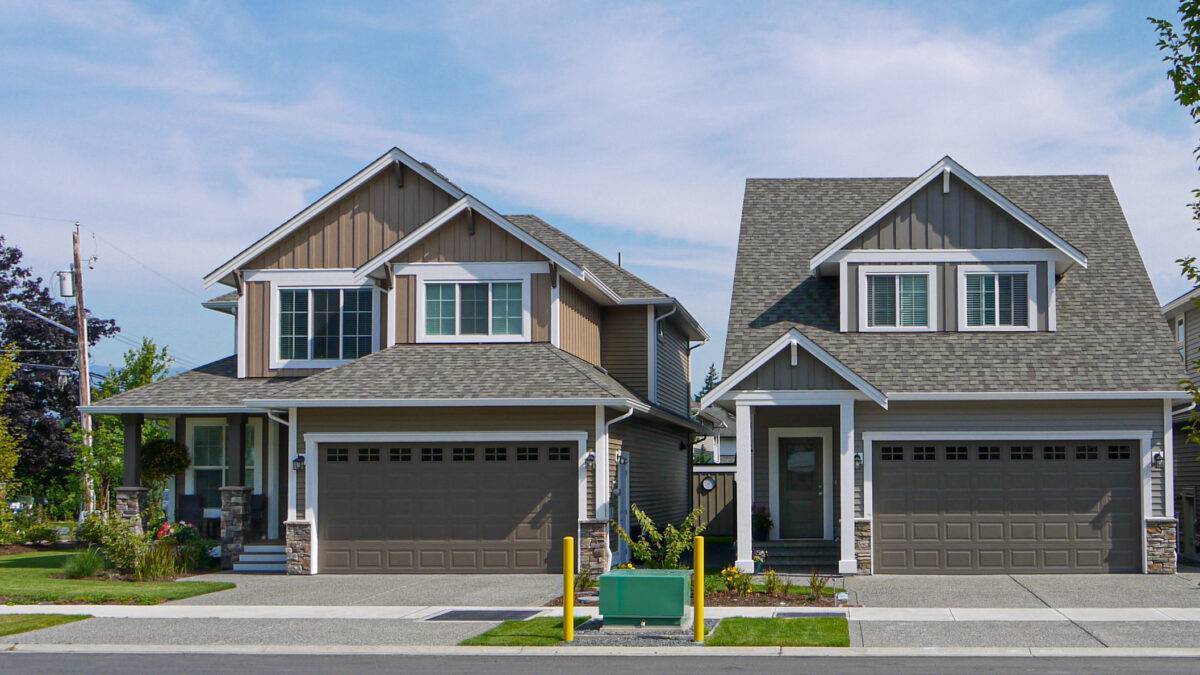 Brand New Residential Houses With Concrete Driveway And Asphalt Road In Front