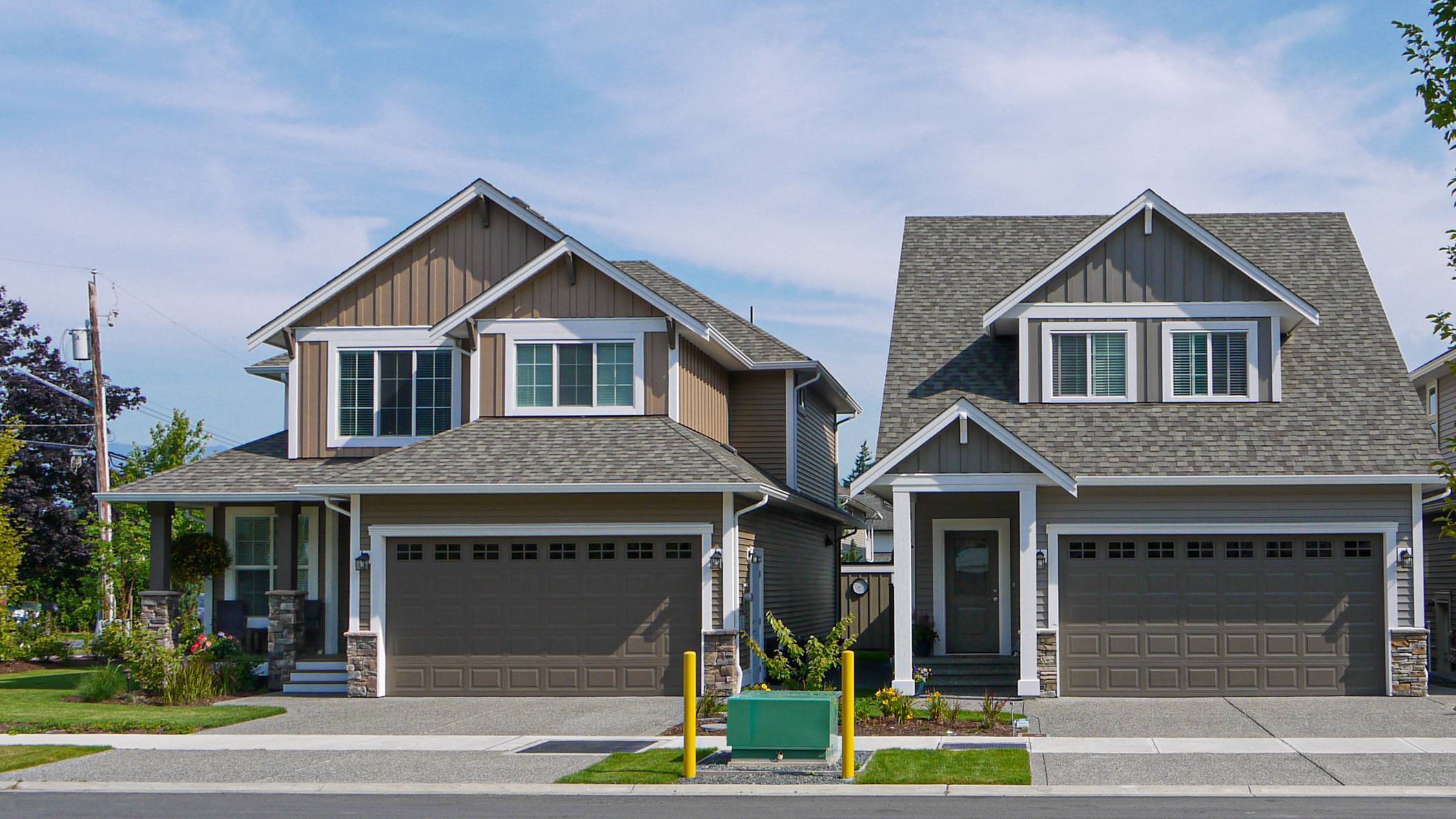 Two houses on the street requiring Tulsa Concrete Contractor for garage construction.