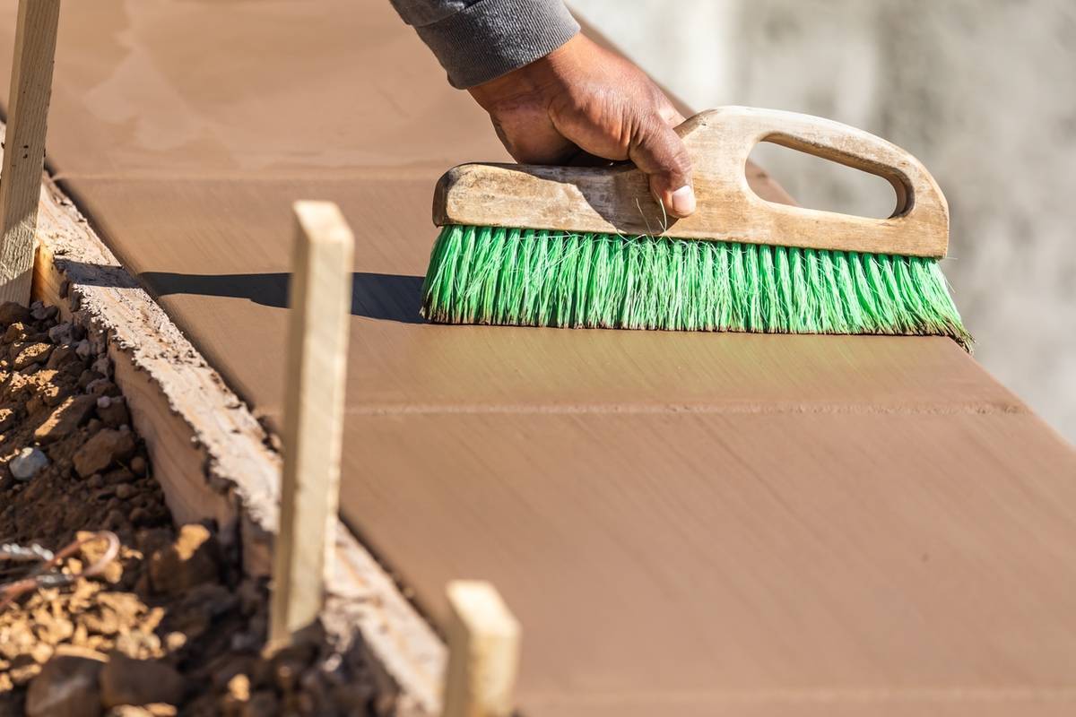 Concrete Contractor Tulsa, Oklahoma 34082024 Construction Worker Using Brush On Wet Cement Forming Coping Aro