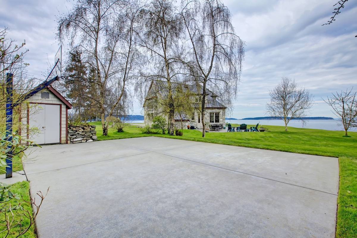 Concrete Outdoor Basketball Court By The Lake With Shed
