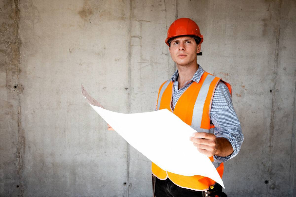 Man Dressed In Orange Vest